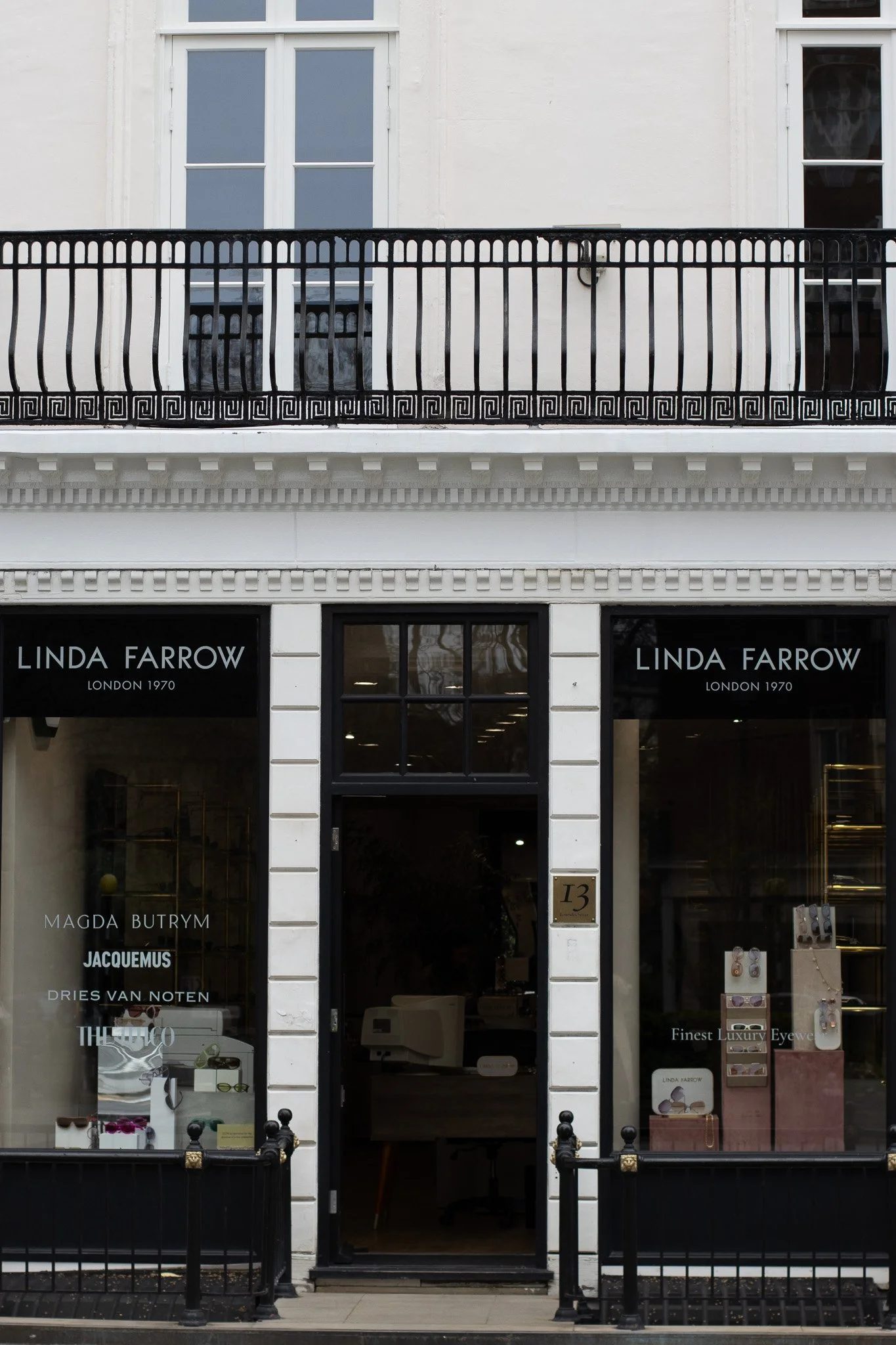 Storefront with the sign 'Linda Farrow London 1970' and display window showcasing luxury eyewear and jewelry. Linda Farrow.